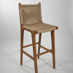 Wooden bar stool with woven backrest in a casual setting