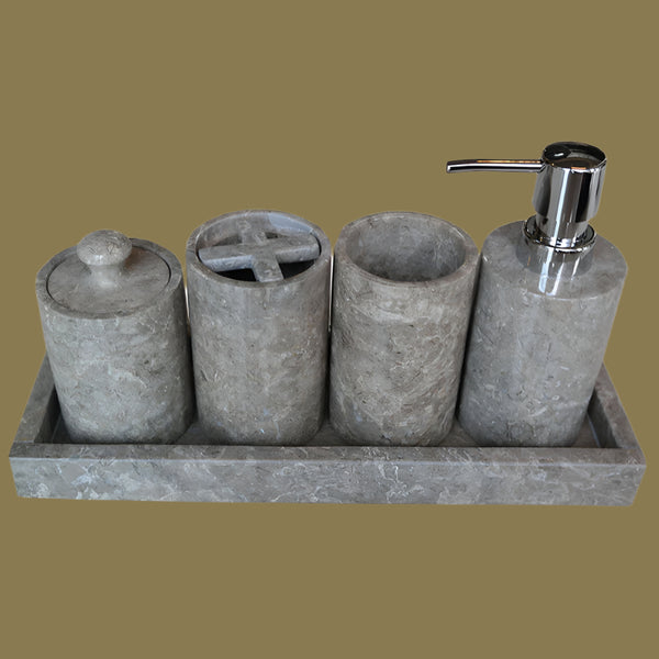 Hospitality Bathroom accessory set with stone-textured bottles and a soap dispenser on a tray.