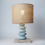 Table lamp with a woven shade on a wooden cabinet against a light gray wall