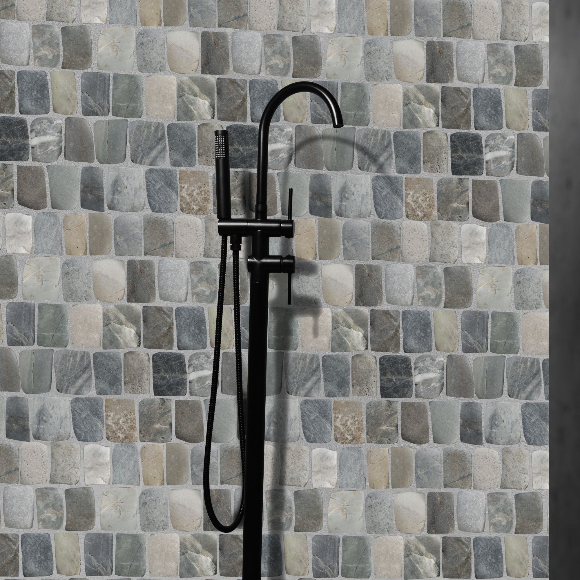 Black shower faucet against a mosaic tile wall with various shades of gray and beige.