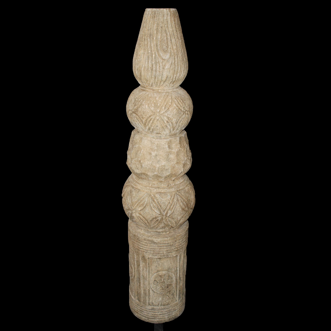 Decorative totem column with intricate carvings on a black background 