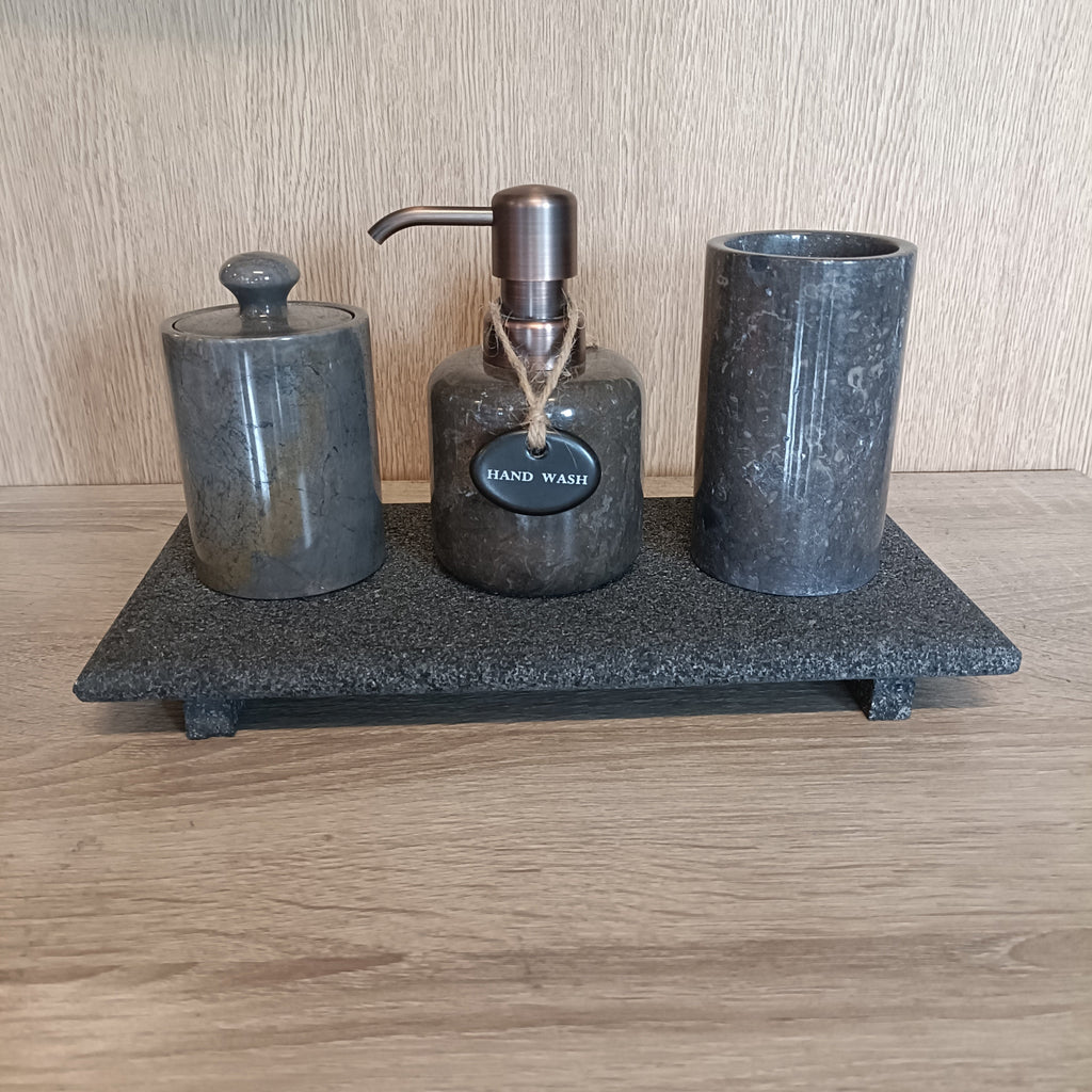 Marble hand soap dispenser on lava tray.