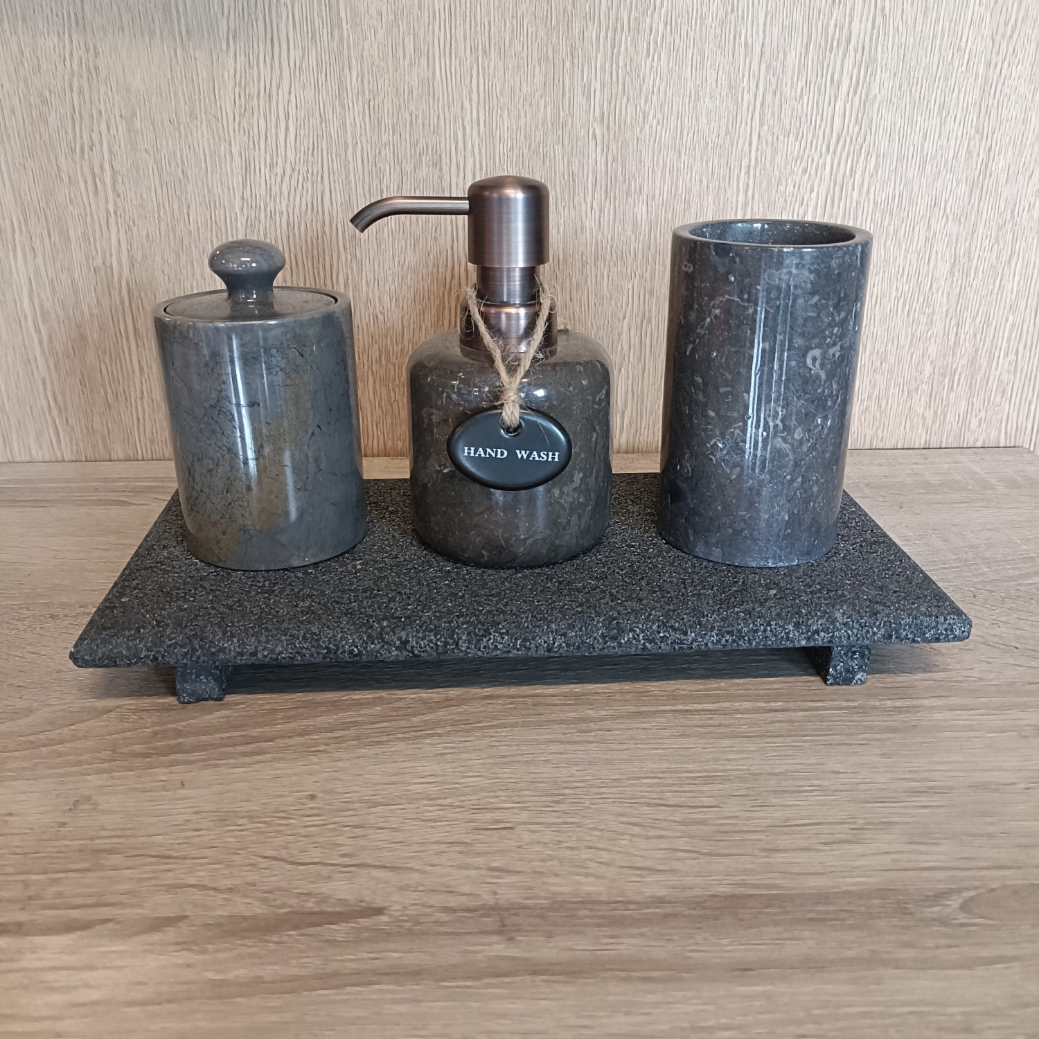 Marble hand soap dispenser on lava tray.