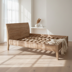 A teak wood bed frame with a low headboard and a grid pattern on the slats, displayed against a textured black background.