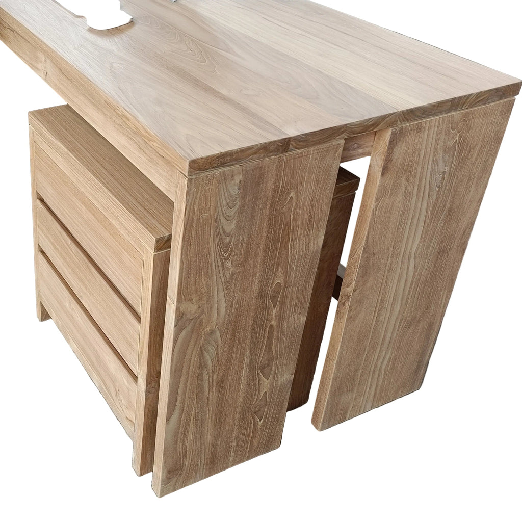 Wooden office desk with a computer monitor and chair in an industrial setting