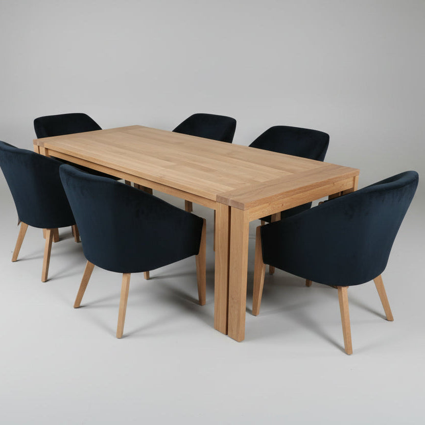 Wooden dining table with six black chairs on a gray background