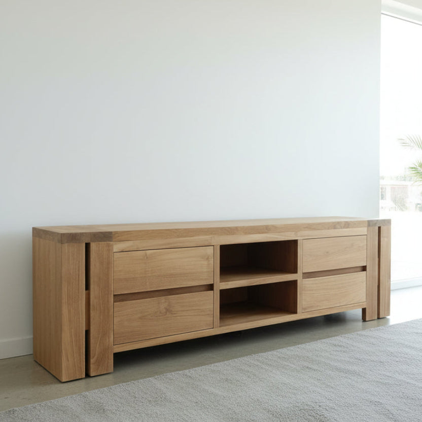 Wooden entertainment console in a modern living room with large windows and plants.