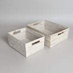 Two woven rectangular towel storage baskets with cutout handles