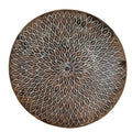 A hand-carved wooden decorative plate with a geometric pattern, predominantly in a black and white color palette.