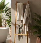 A straight bamboo towel rack with multiple rungs, showing the natural color and texture of bamboo.