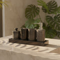 Set of black marble bathroom containers with a silver pump on a white background