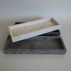 Two stone trays, one beige and one gray, made for hospitality supply