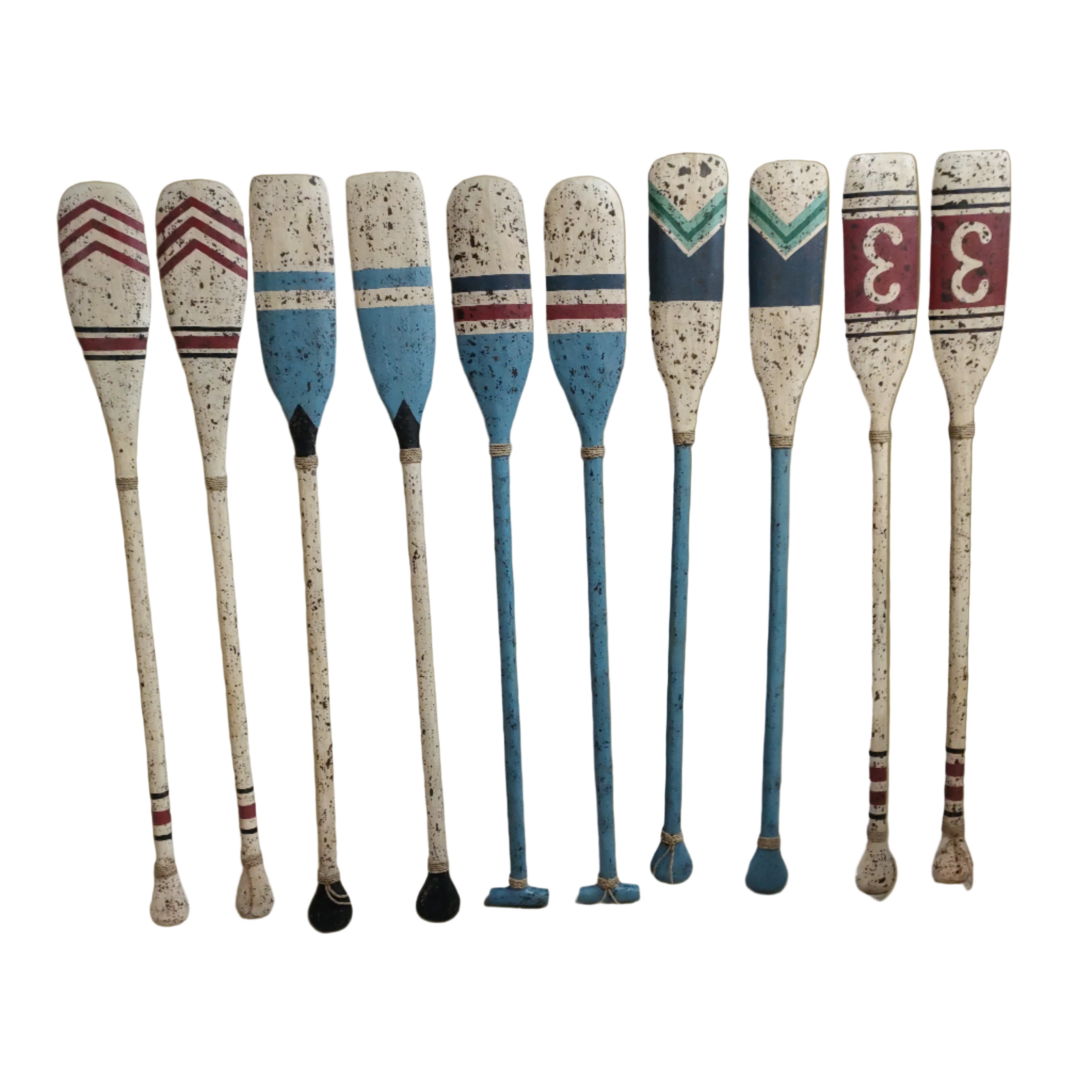 Set of decorative wooden oars with speckled handles and striped blades.