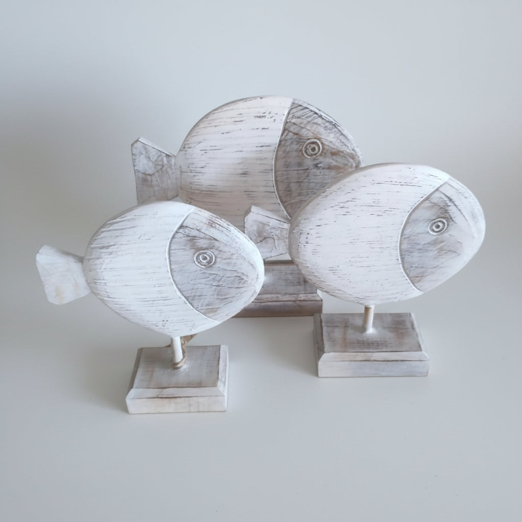 Three wooden fish sculptures on stands, villa and home decoration.