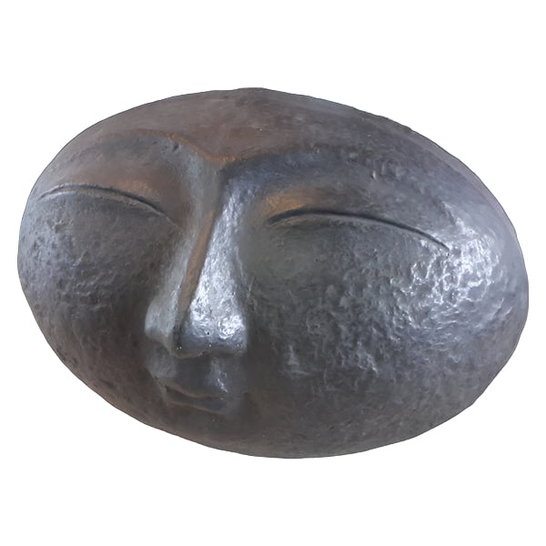 A sculpture of a smiling face with closed eyes, finished in black paint.