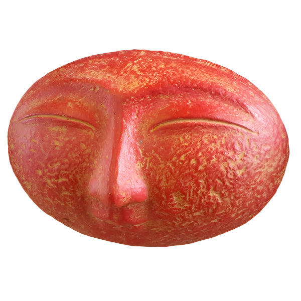 A sculpture of a smiling face with closed eyes, finished in black paint.